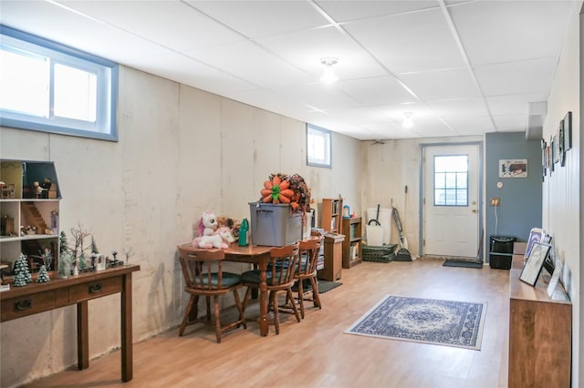 dining space with a paneled ceiling and wood finished floors