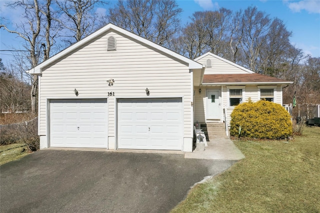 ranch-style house featuring a front lawn, a garage, driveway, and a shingled roof