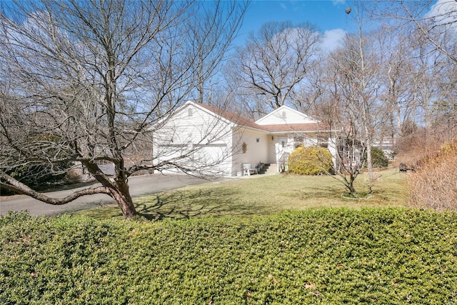 exterior space featuring concrete driveway and an attached garage