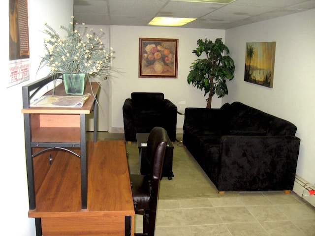 living room featuring a paneled ceiling and a baseboard radiator