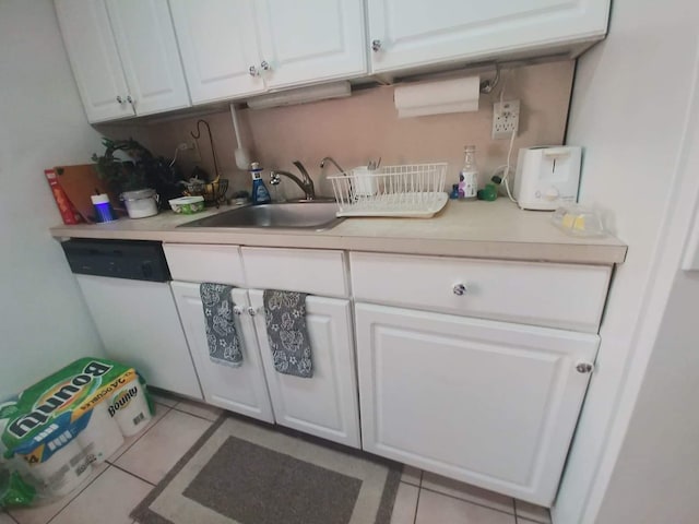 kitchen with a sink, dishwasher, white cabinets, and light countertops