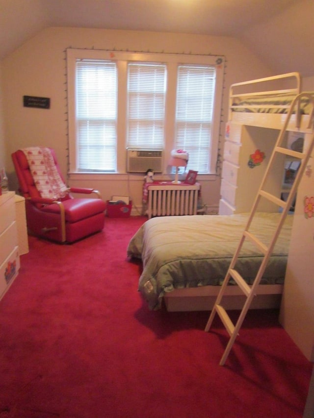 carpeted bedroom with lofted ceiling, multiple windows, radiator heating unit, and cooling unit