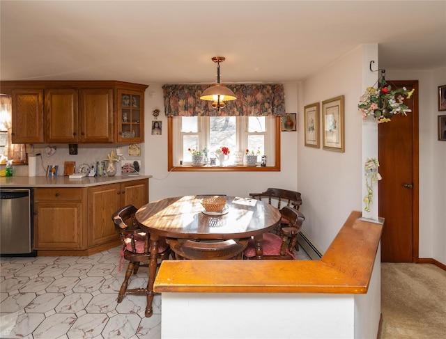 dining area featuring a baseboard heating unit, baseboards, and light carpet