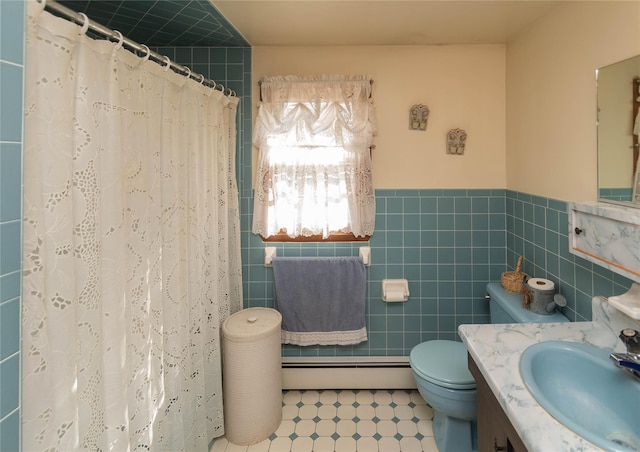 bathroom with a baseboard heating unit, a wainscoted wall, toilet, a shower with curtain, and tile walls