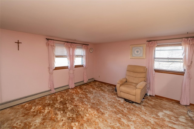 unfurnished room featuring a baseboard heating unit, baseboards, and carpet flooring