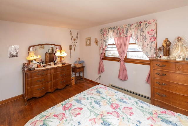 bedroom featuring baseboard heating, baseboards, and wood finished floors