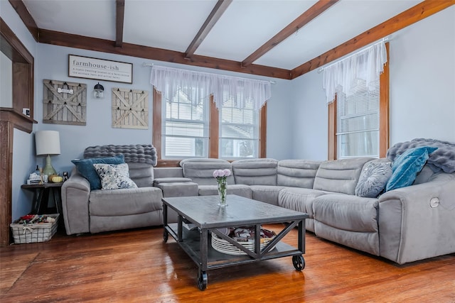 living room featuring beam ceiling and wood finished floors