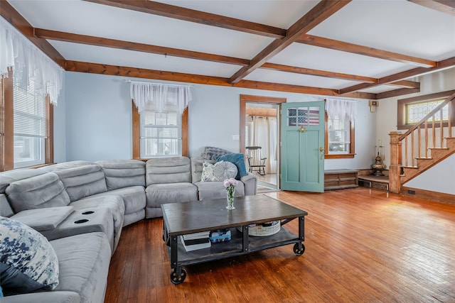 living area with stairway, baseboards, beamed ceiling, and hardwood / wood-style floors