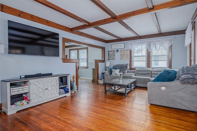 living area featuring hardwood / wood-style floors and beamed ceiling