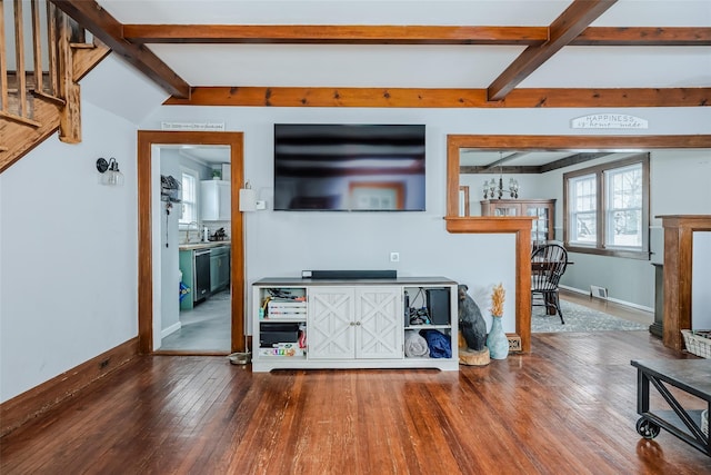 living room with beam ceiling, baseboards, and hardwood / wood-style flooring