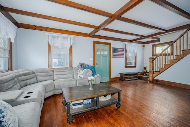 living area with stairs, beam ceiling, wood finished floors, and baseboards