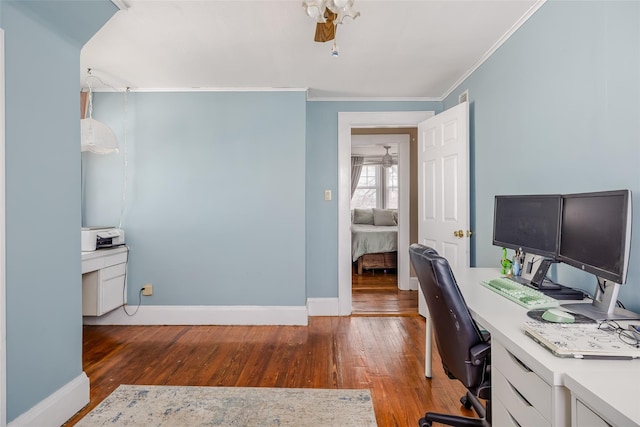 office space with ceiling fan, wood finished floors, baseboards, and ornamental molding