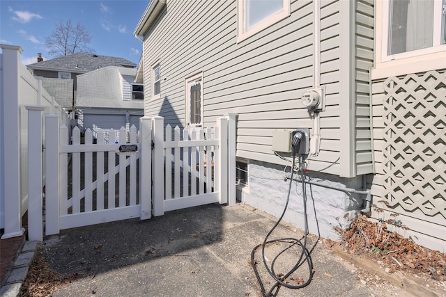 view of side of property featuring a gate and fence