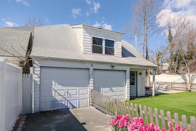 detached garage featuring fence