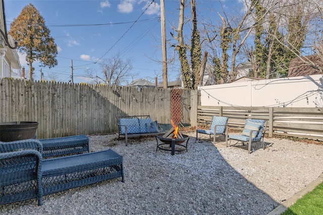 view of yard with a fenced backyard and an outdoor fire pit