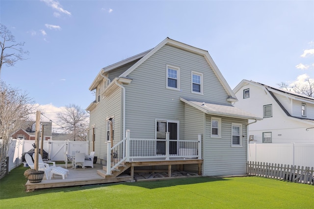 back of house featuring a deck, a gate, a yard, and a fenced backyard