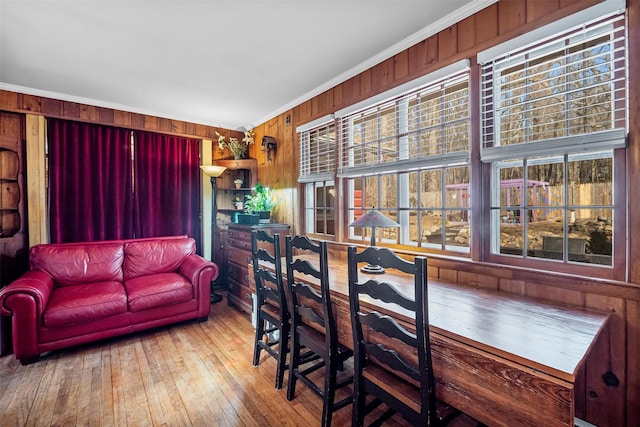 3 Rodman Pl, Spring Valley, NY 10977 - dining space with ornamental molding, wood walls, and hardwood / wood-style floors