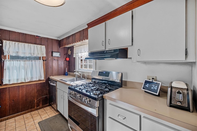 3 Rodman Pl, Spring Valley, NY 10977 - kitchen with stainless steel appliances, under cabinet range hood, light countertops, white cabinets, and wooden walls