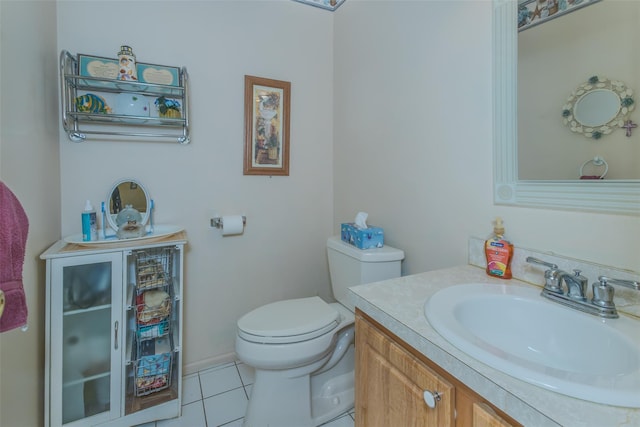 half bathroom with tile patterned flooring, toilet, and vanity