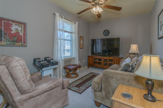 living room with ceiling fan and carpet