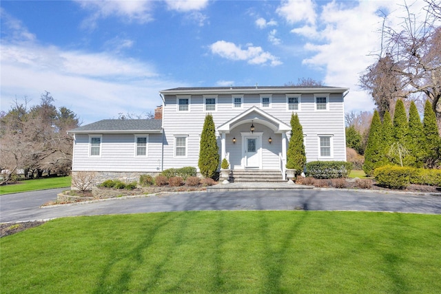 8 Bradshaw Ln, Northport, NY 11768 - colonial inspired home with a front lawn and driveway