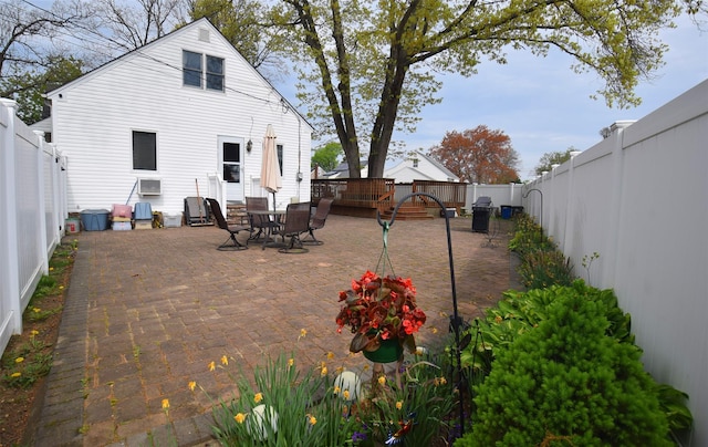 back of property featuring a patio, a fenced backyard, and outdoor dining space