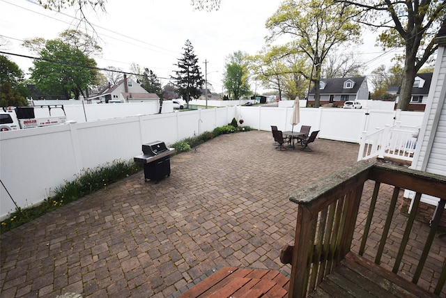 view of patio / terrace featuring a residential view, outdoor dining area, and a fenced backyard