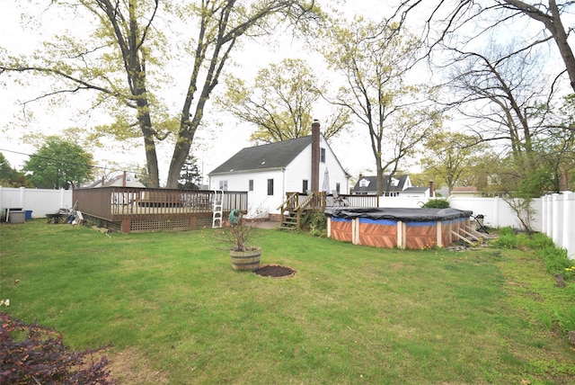 view of yard with a fenced backyard, a fenced in pool, and a deck