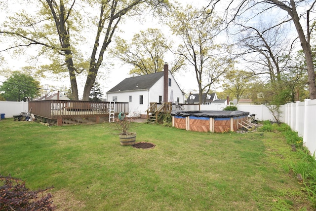 view of yard featuring a fenced backyard, a fenced in pool, and a deck