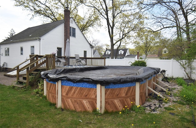 view of swimming pool with a fenced in pool, fence, and a wooden deck
