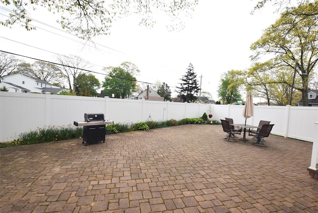 view of patio with a fenced backyard, grilling area, and outdoor dining space
