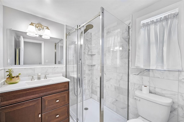 bathroom featuring a shower stall, vanity, tile walls, and toilet