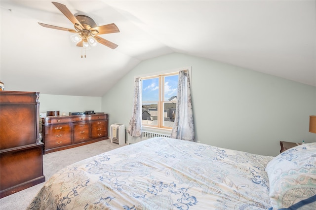 carpeted bedroom featuring radiator heating unit, a ceiling fan, and vaulted ceiling