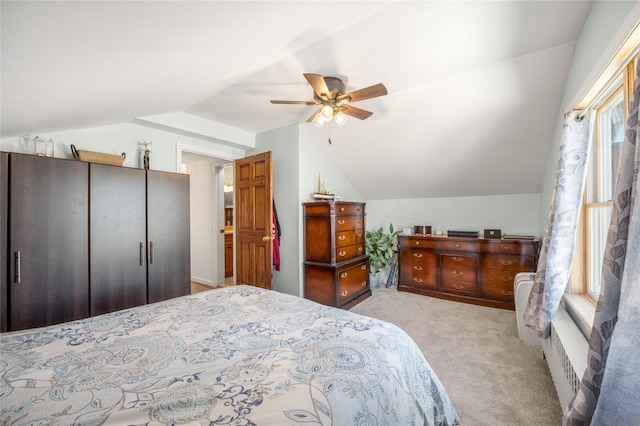 carpeted bedroom with a ceiling fan and lofted ceiling