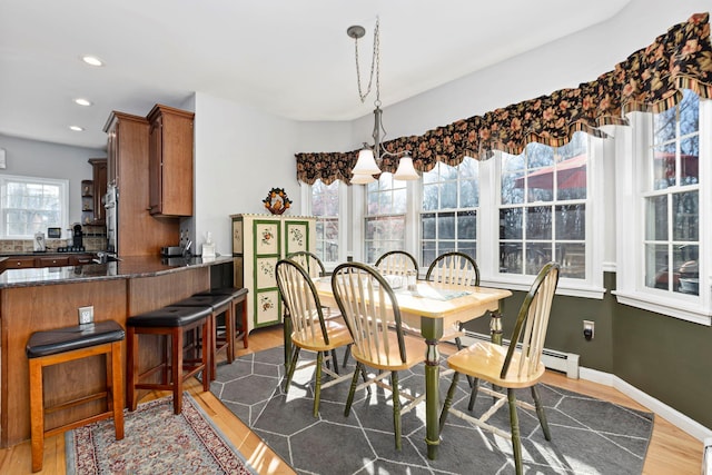 dining room featuring recessed lighting, baseboards, baseboard heating, and dark wood-style floors