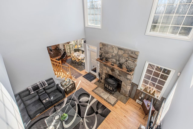 living room with a wood stove and wood finished floors