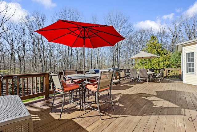 wooden deck featuring outdoor dining area