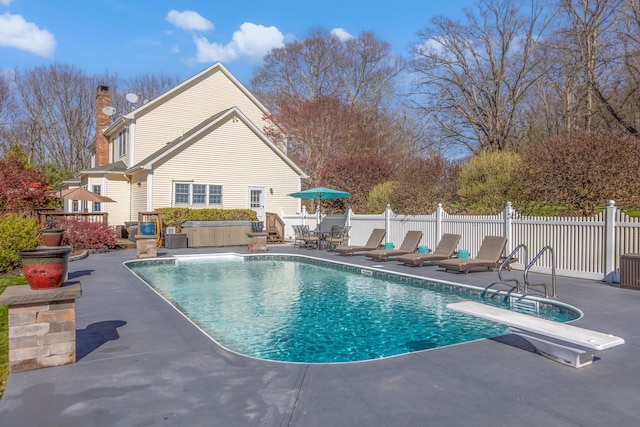 view of swimming pool featuring a diving board, a fenced in pool, a patio, and fence