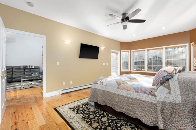 bedroom featuring light wood-type flooring, recessed lighting, baseboards, baseboard heating, and ceiling fan