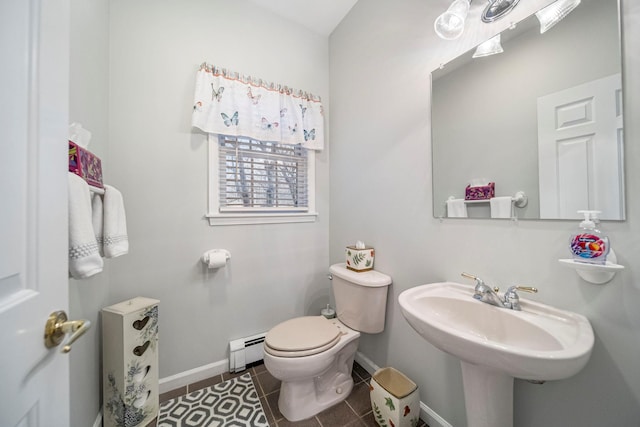 half bath featuring tile patterned floors, toilet, baseboards, and a baseboard radiator