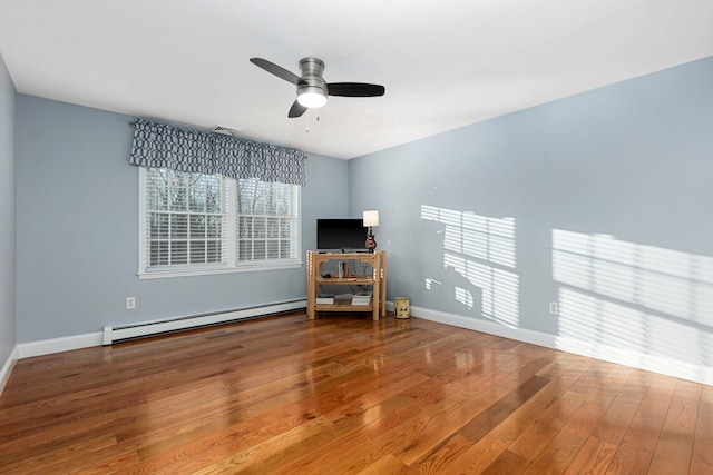 empty room with visible vents, wood-type flooring, baseboards, baseboard heating, and ceiling fan