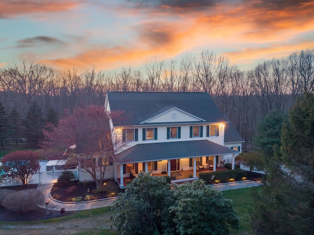 view of front of house with a porch and a front lawn