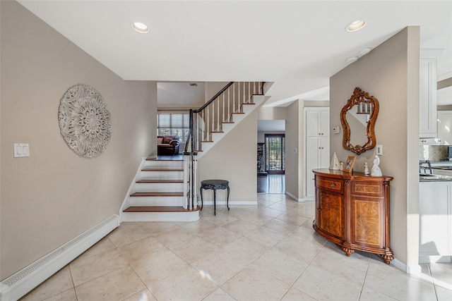 stairs with recessed lighting, a baseboard heating unit, and baseboards