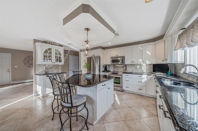 kitchen featuring light tile patterned floors, white cabinetry, stainless steel appliances, and a sink