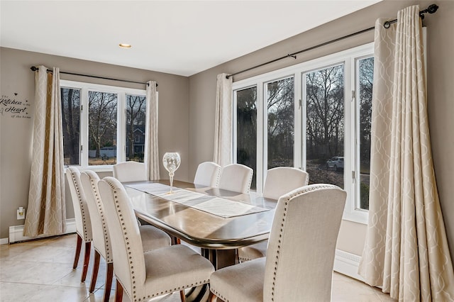 dining room with plenty of natural light, baseboards, and light tile patterned floors