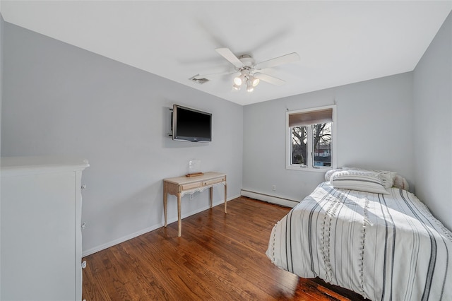 bedroom with a ceiling fan, baseboards, wood finished floors, visible vents, and a baseboard radiator