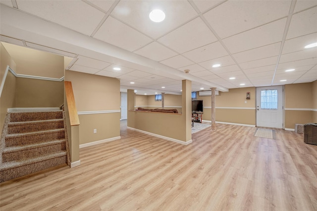 basement featuring stairway, baseboards, and wood finished floors