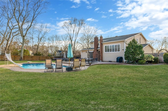 view of yard with a fenced in pool, a patio, and fence