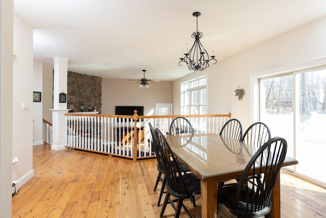 dining room featuring light wood-type flooring, baseboards, and ceiling fan