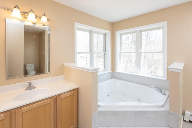 bathroom with a baseboard heating unit, vanity, and a whirlpool tub